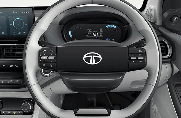 Tata Tiago EV premium leather-wrapped steering wheel with multi-function mounted audio controls, cruise control, voice command buttons, phone controls and trip computer for enhanced driving safety and convenience in electric vehicle